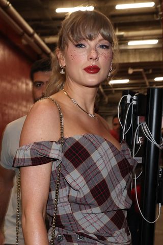 Taylor Swift arrives at the chiefs game wearing a plaid set with glitter freckles and red lipstick