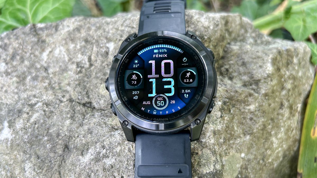 Garmin Fenix 8 placed on a rock outdoors