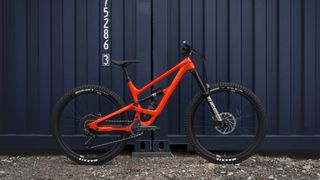 Side view of the flame red Capta Core 3 mountain bike