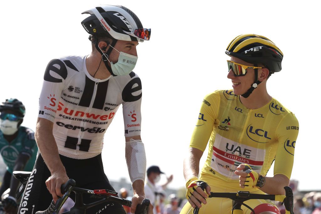 Team UAE Emirates rider Slovenias Tadej Pogacar wearing the overall leaders yellow jersey R attends the start of the 21st and last stage of the 107th edition of the Tour de France cycling race 122 km between ManteslaJolie and Champs Elysees Paris on September 20 2020 Photo by KENZO TRIBOUILLARD AFP Photo by KENZO TRIBOUILLARDAFP via Getty Images