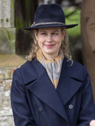 Lady Louise Windsor styled the scarf with her sophisticated navy coat