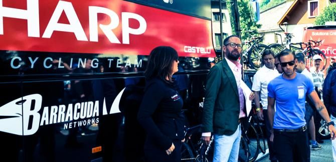 General manager Jonathan Vaughters stands outside the team bus before the start of the race in Bourg D&rsquo;Oisans