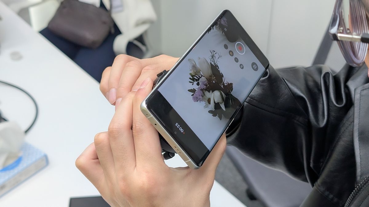 RealMe Interchangeable Lens Concept phone held in a hand