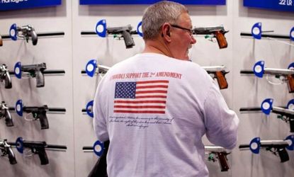 Jerry Kunzer looks at a Smith & Wesson display during the NRA's annual meeting in St. Louis on April 14.