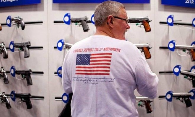 Jerry Kunzer looks at a Smith &amp;amp; Wesson display during the NRA&amp;#039;s annual meeting in St. Louis on April 14.