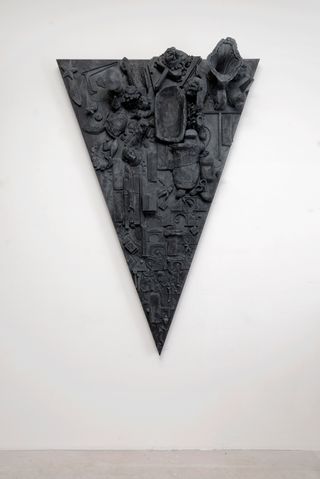 A series of triangular relief sculptures by Isabelle Cornaro