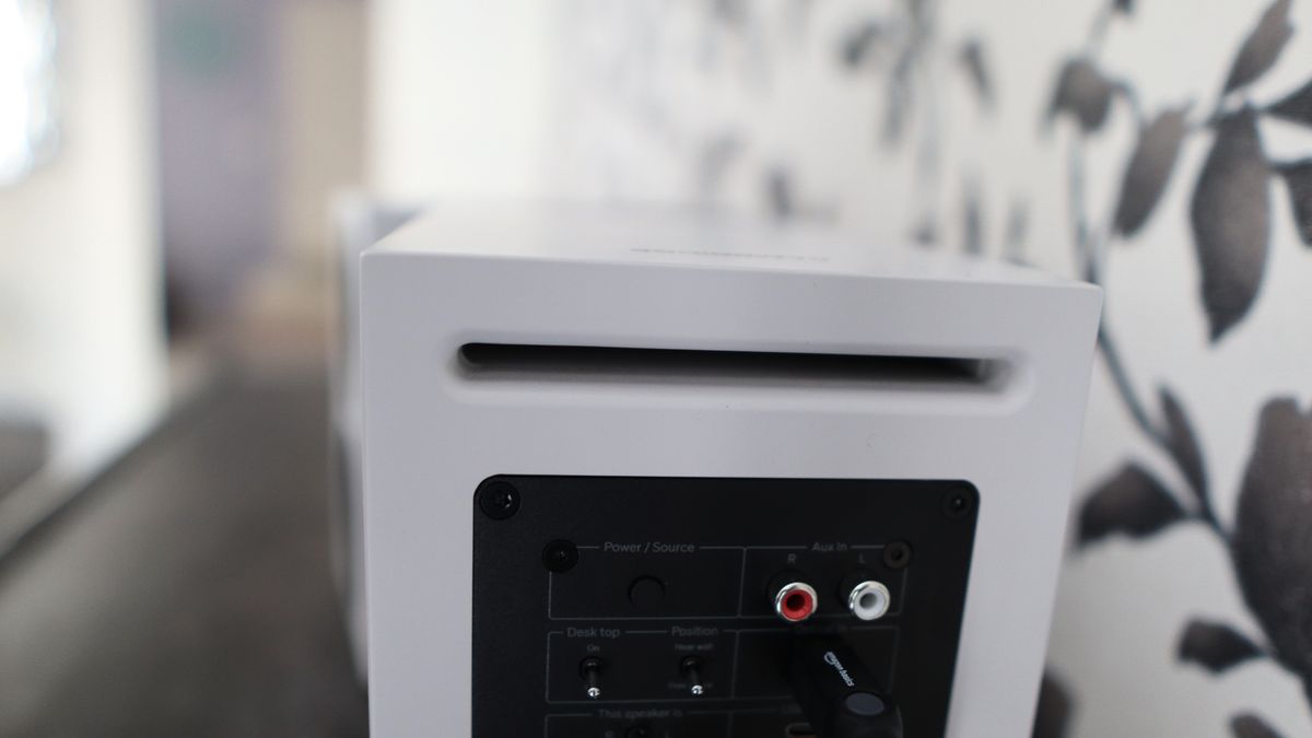 Cambridge Audio's L/R S speakers on a desk. The speakers are white with black tweeters.