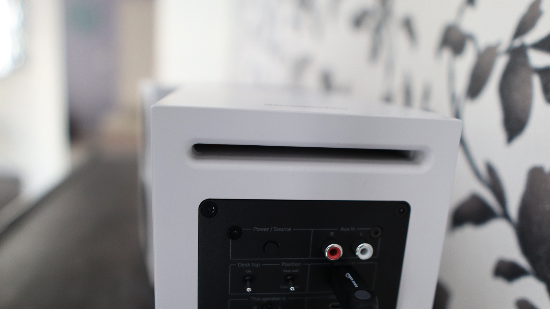Cambridge Audio's L/R S speakers on a desk. The speakers are white with black tweeters.