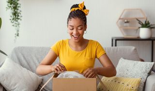 happy black women opening up box