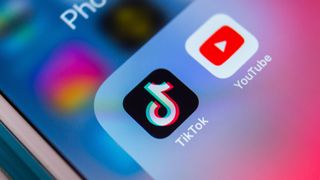 TikTok and YouTube apps side-by-side on an iPhone