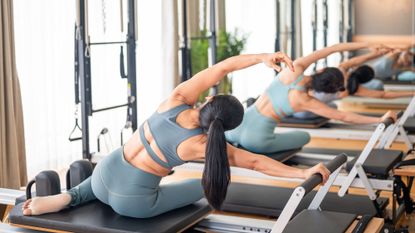 How to do Reformer Pilates at home: Two women on Reformer machines