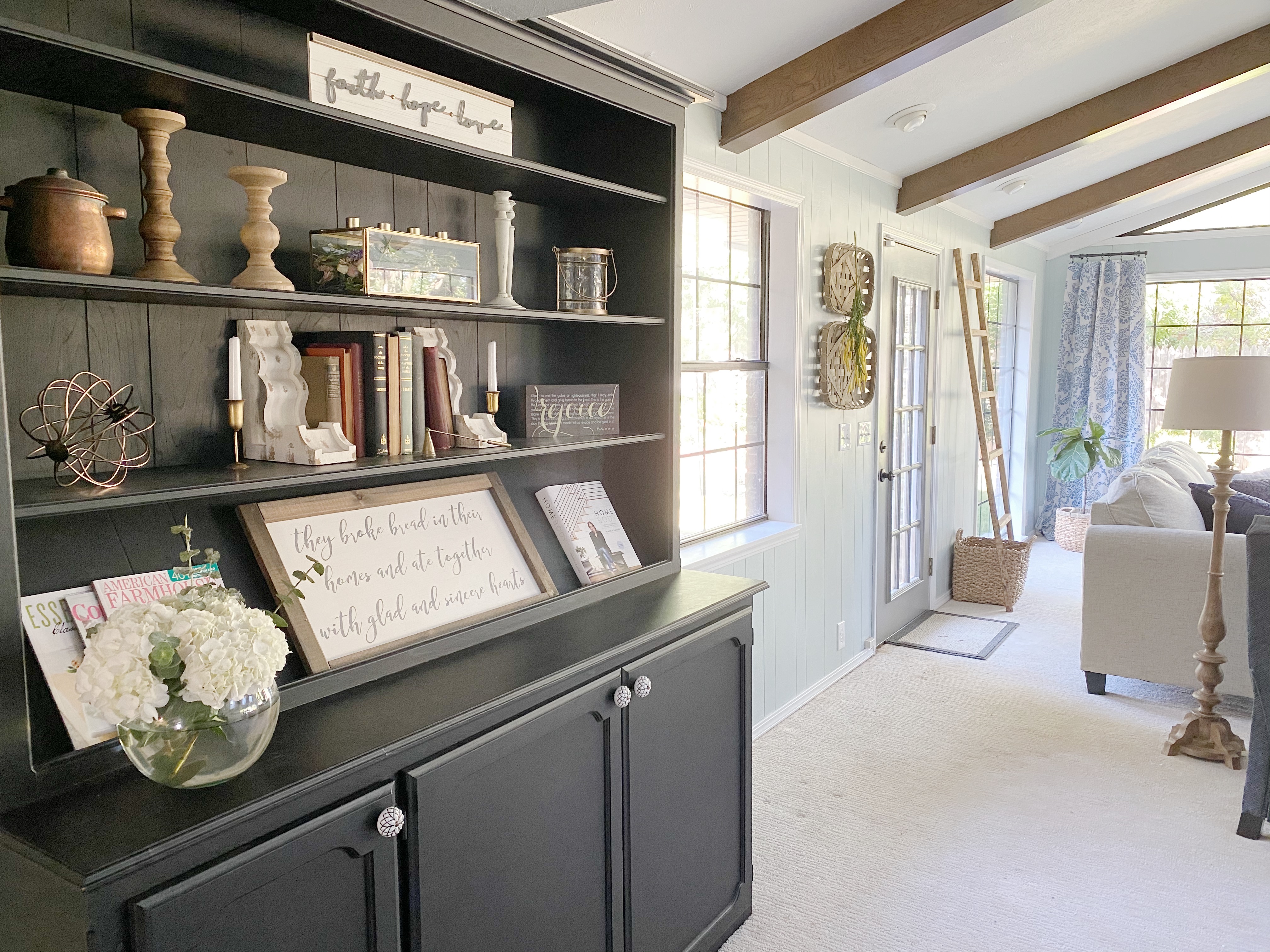 Built in black dining room hutch in open plan living room