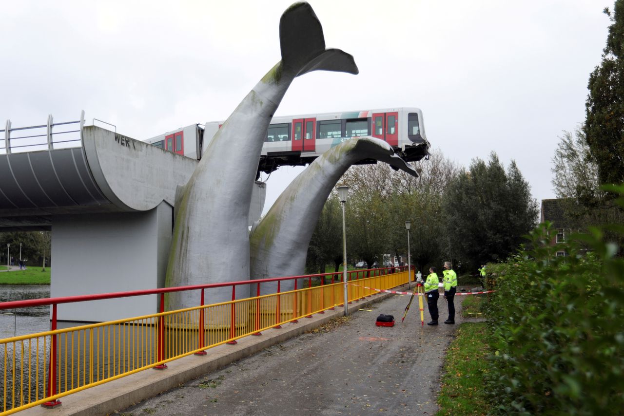 A train being saved by a sculpture.