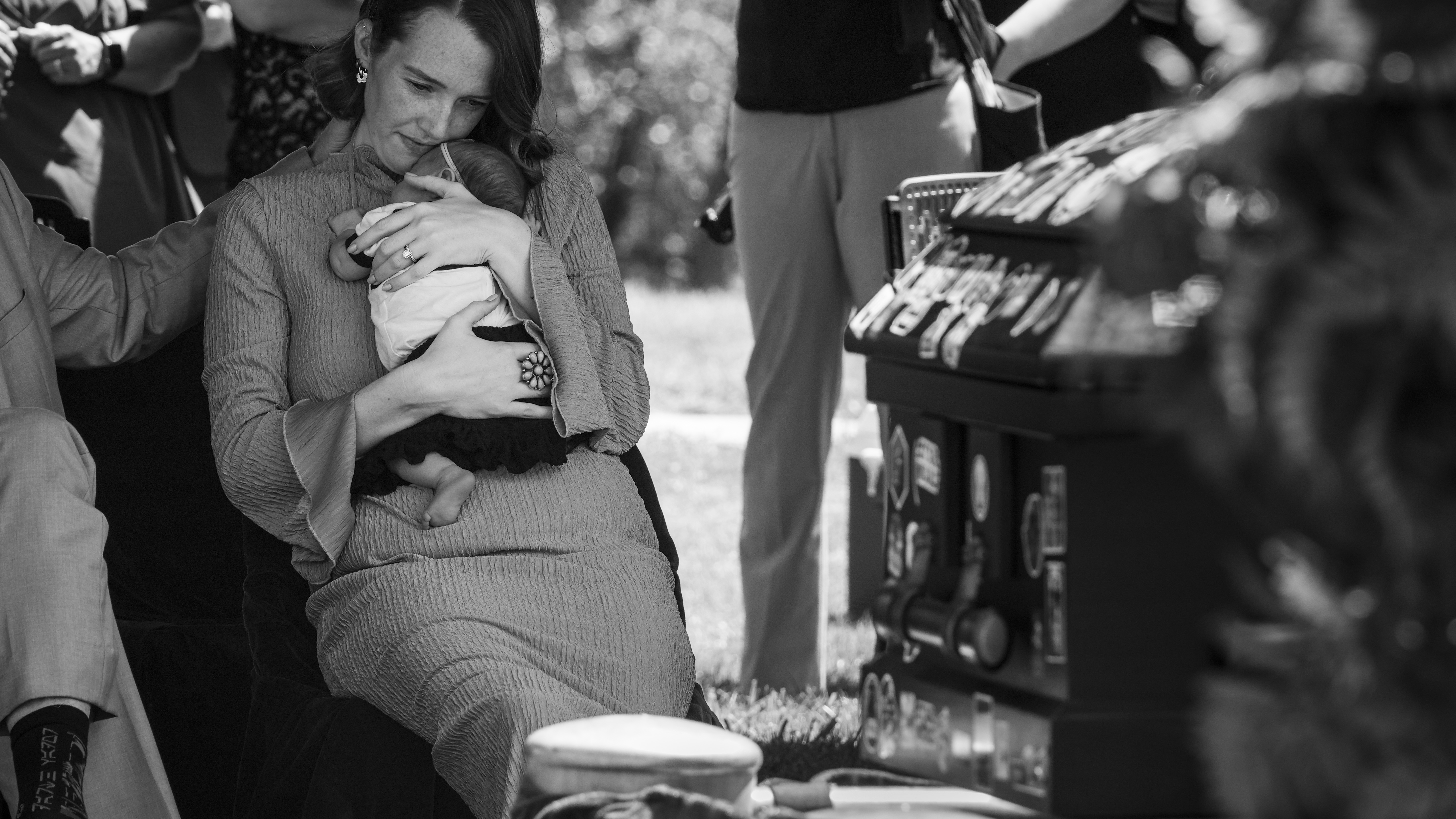 Shay Wright Martin holds her infant daughter, AmyLou Martin, at the burial of Shay's husband, Tanner Martin, at the American Fork Cemetery on July 5, 2025