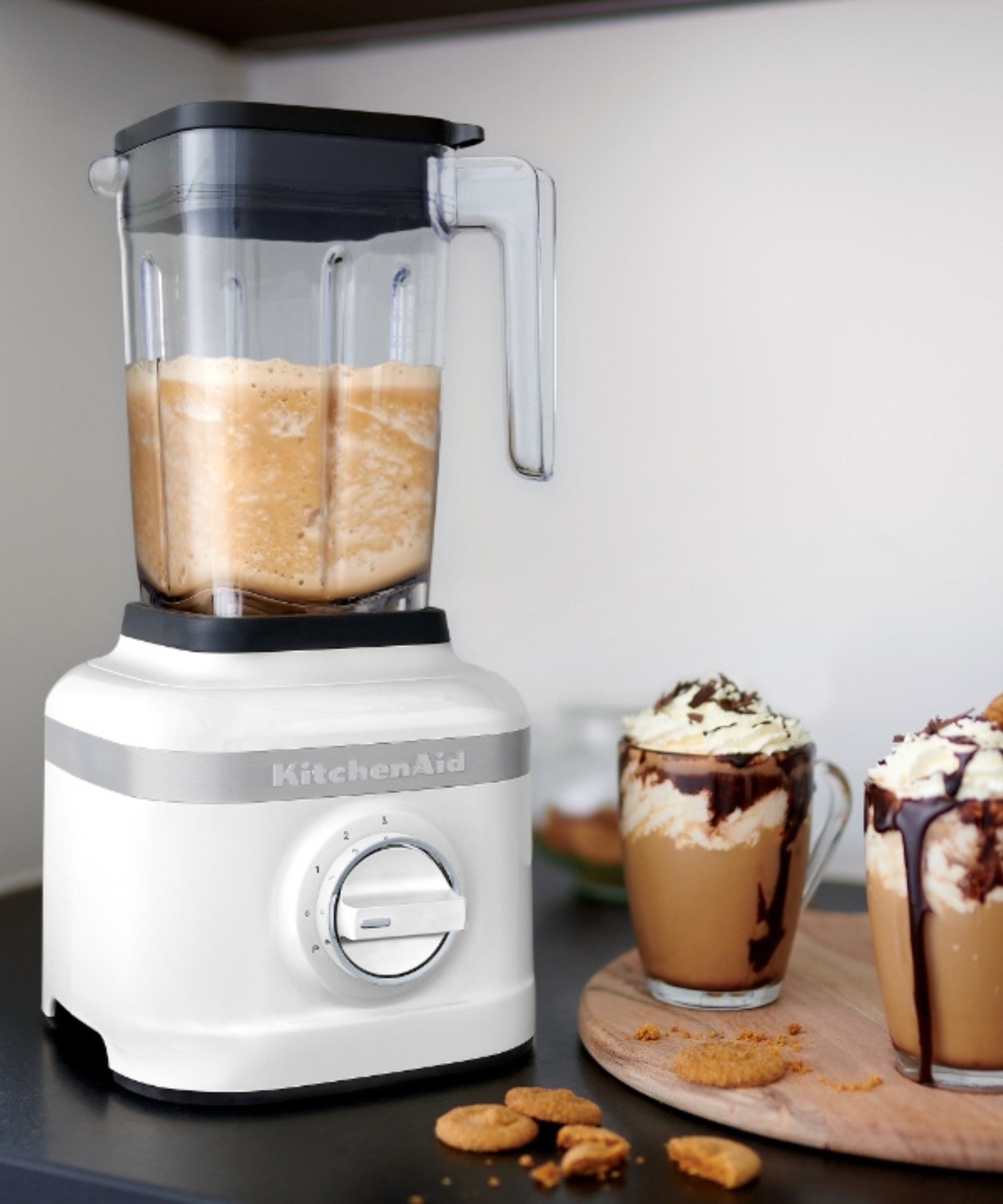 Two chocolate biscoff milkshakes next to a KitchenAid K130 classic range blender