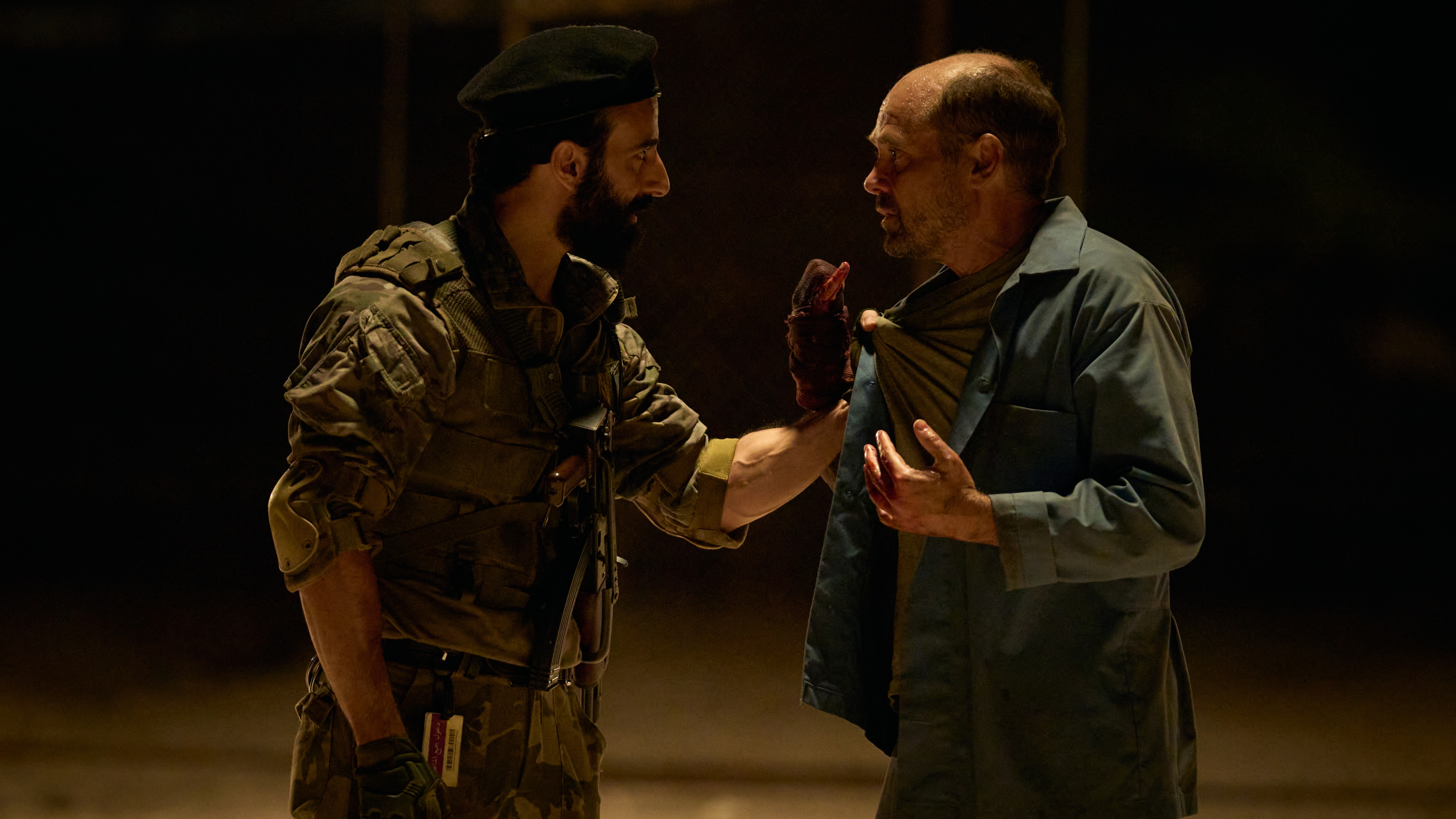 Jasper argues with a prison guard at night in The Assassin