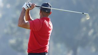Tiger Woods holds his finish on an iron shot