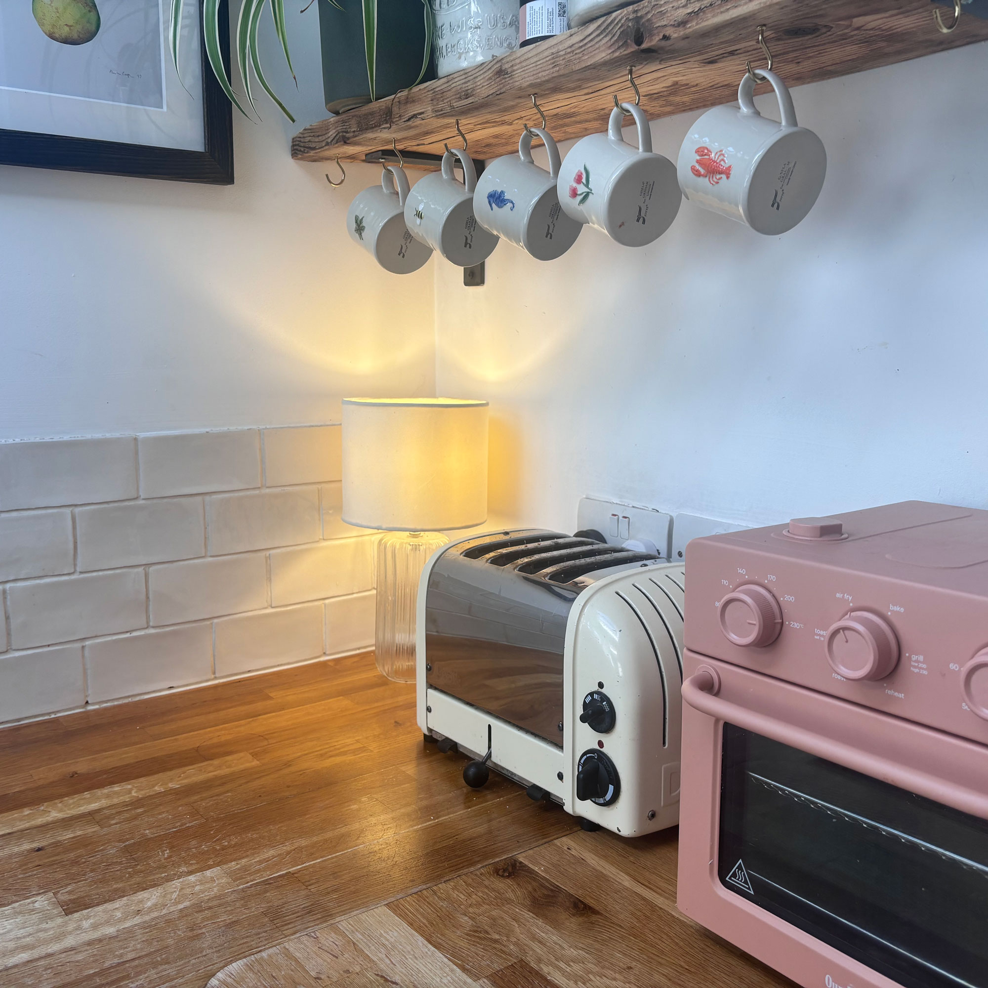 corner of kitchen with hanging mugs and wooden worktops