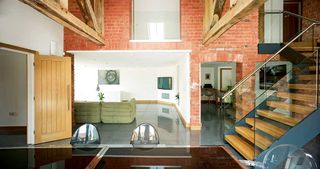 open plan living space with exposed brick wall in converted barn