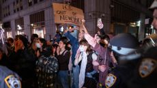 NEW YORK, NEW YORK - OCTOBER 21: People protest against an earlier raid by federal agents outside of 26 Federal Plaza on October 21, 2025 in New York City. 