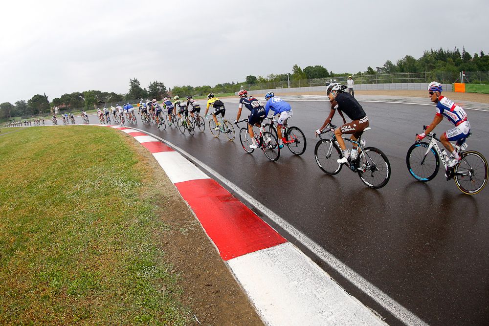 The peloton negotiates the F1 track in Imola.