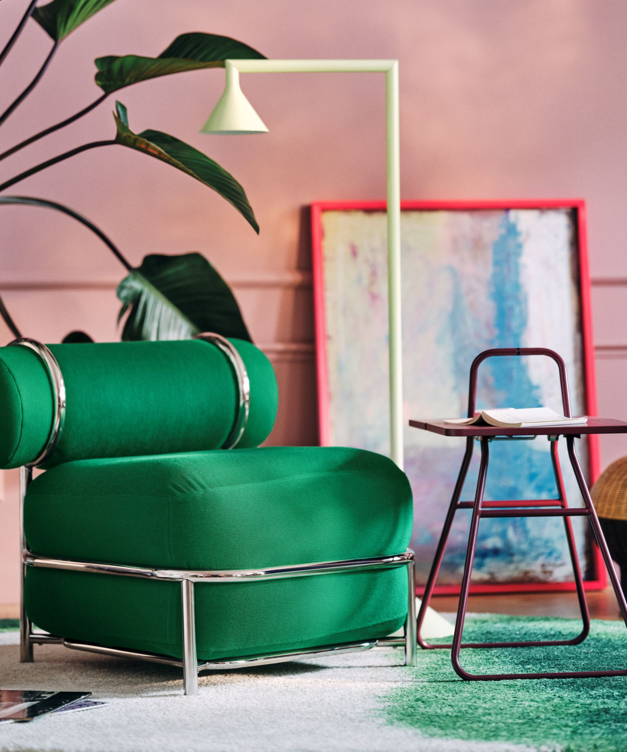 an inflatable green chair, a red foldable side table, and a bending lamp from IKEA's PS collection