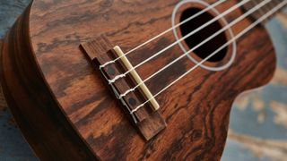 Close up of the bridge and strings on a Kahua ukulele