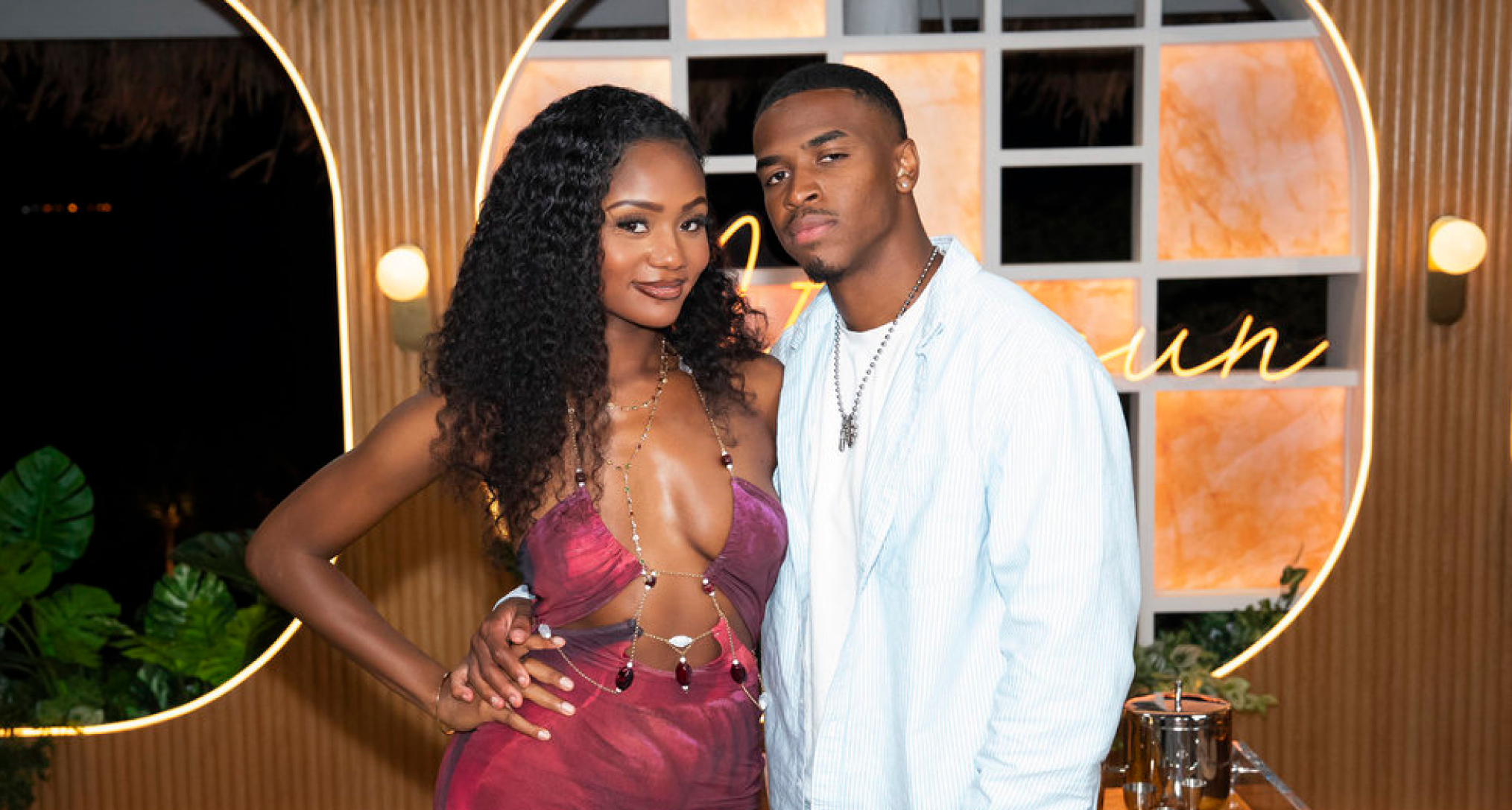 tierra titi davis wearing a red dress posing with kc chandler wearing an all white outfit on the love island usa season 8 after show aftersun 