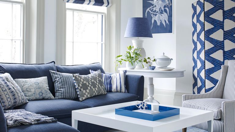 Blue and white living room with large navy sofa