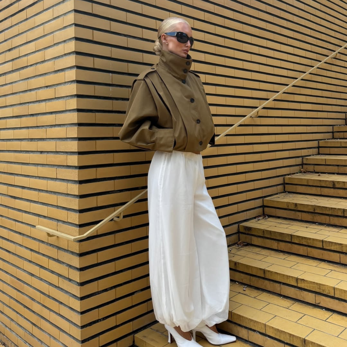 lovisa worge wears a white funnel neck jacket and matching balloon trousers