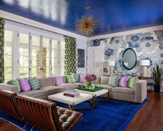 maximalist living room with dark blue ceiling and blue floral wallpaper