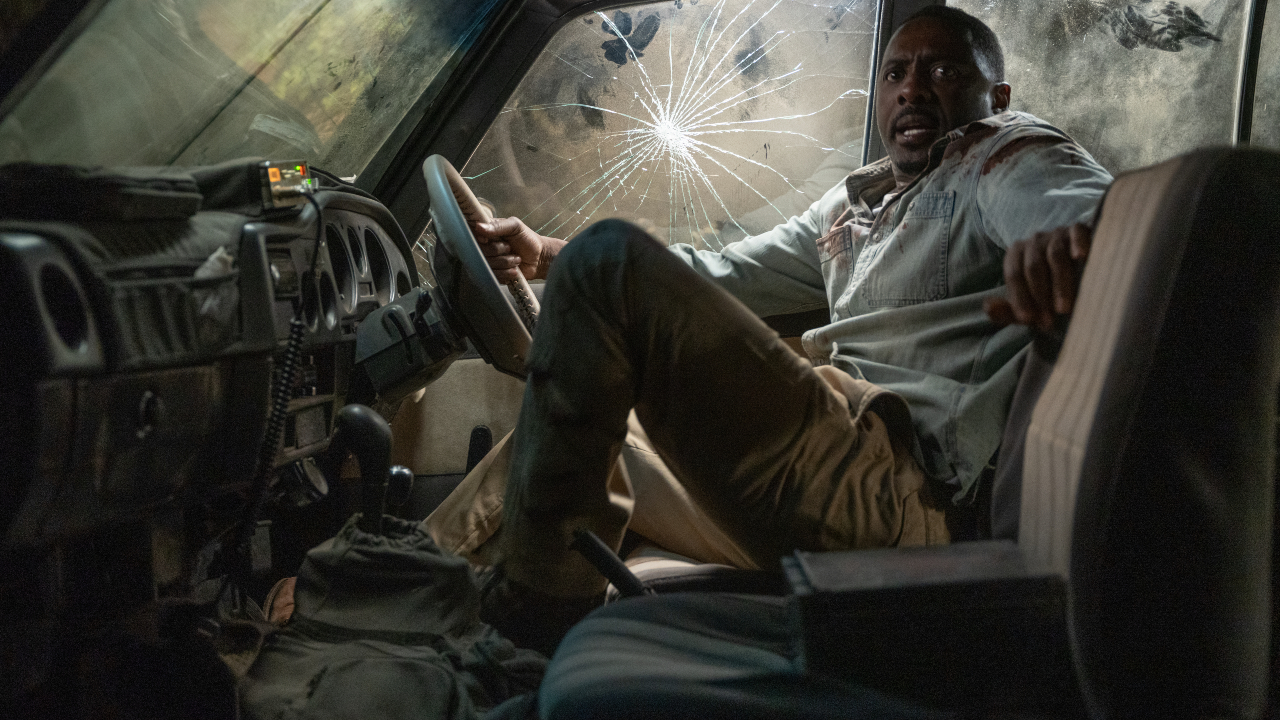 Idris Elba retreats in fear in his car in Beast.