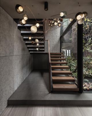 Striking staircase with sculpture lighting at the Vancouver House Penthouse