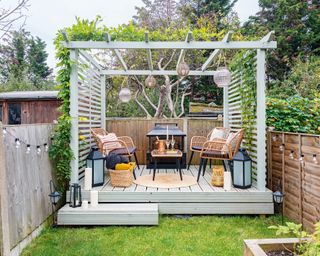 modern backyard with gray pergola and rattan chair and coffee table set