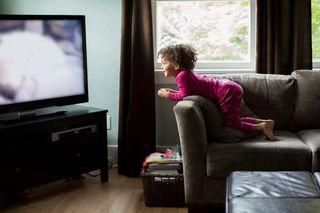 A kid watching TV