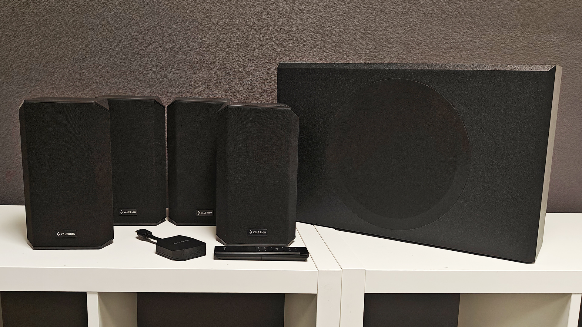 Valerion Thunderbeat 4.1.2 surround sound system on white wooden shelving units