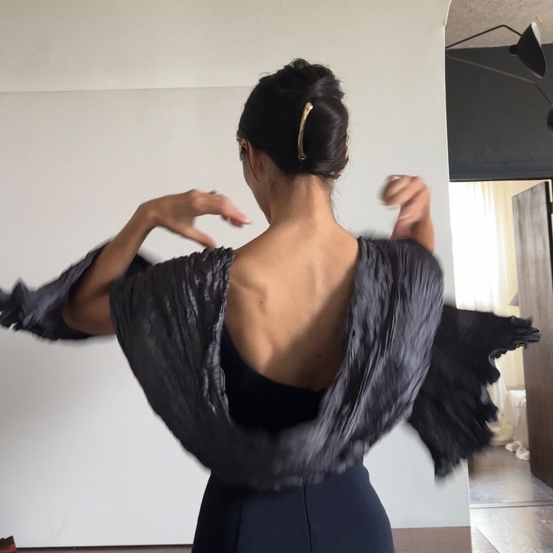 Alexis Badiyi wearing an open back top with a shawl 