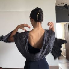 Alexis Badiyi wearing an open back top with a shawl 