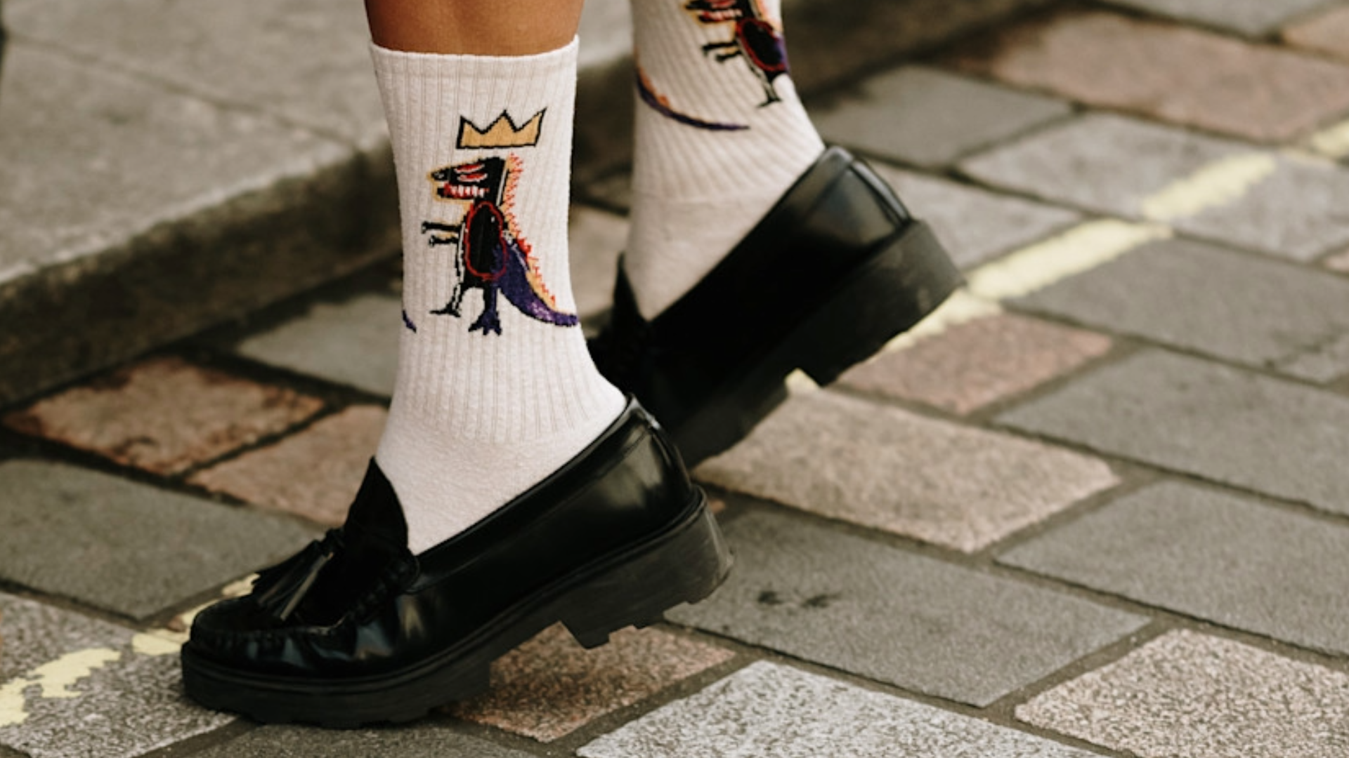 woman wearing black loafers and white socks.
