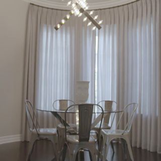 dining room with white curtains and dining table