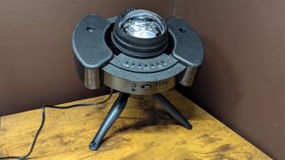 YgiTK Northern Galaxy Lights Projector during Review, on a wooden table against a dark coloured wall