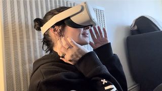 Fitness writer Sam Hopes testing Meta Quest 2 VR meditation with her hands touching the headset