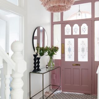 White hallway with period style front door painted pink