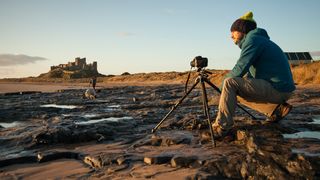 landscape photographer outside with camera on a tripod