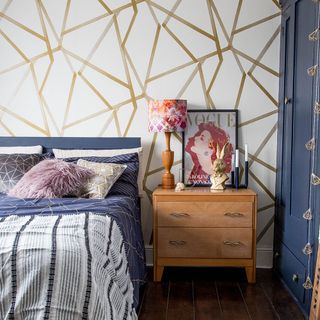 bedroom with geometric print wallpaper and side table