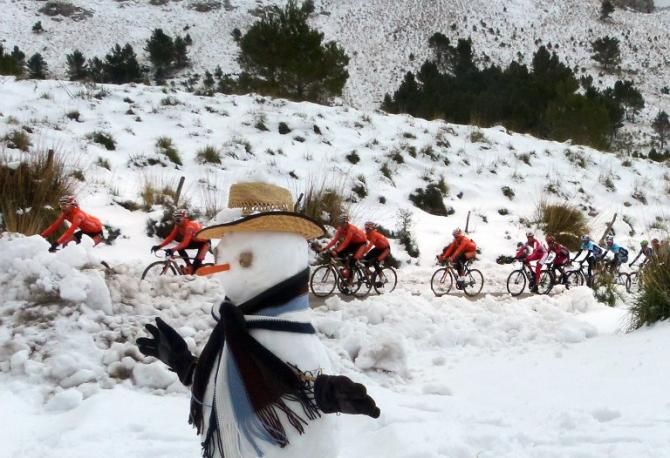 Cold snap... The peloton rides past a snowman on a road in the Tramontana Mountains during the third stage of Mallorca Challenge