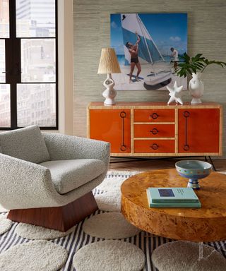A living room with a cozy armchair, a console table and a coffee table