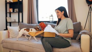 Dog and woman open package