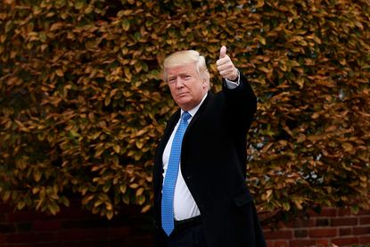 Donald Trump waves from his golf course in New Jersey