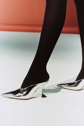 A pair of high-shine silver metallic shoes